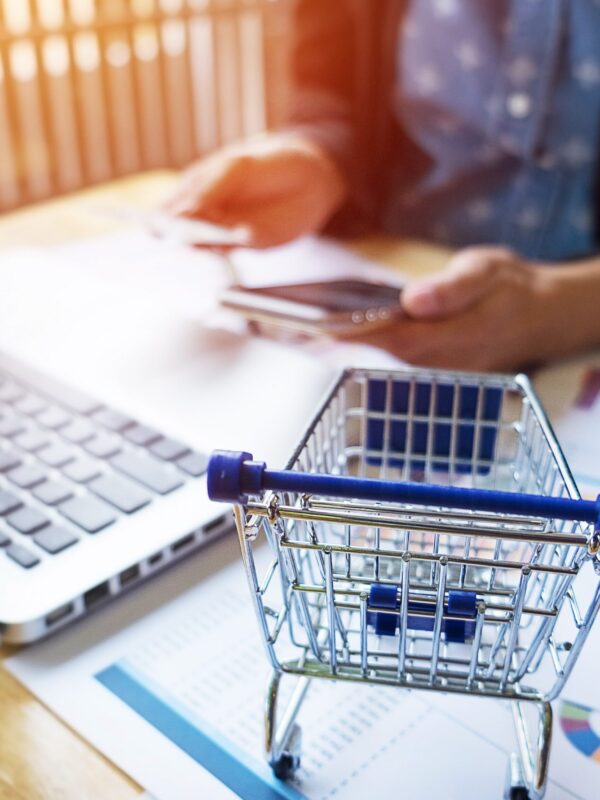 Cropped image of woman inputting card information and key on phone or laptop while shopping online