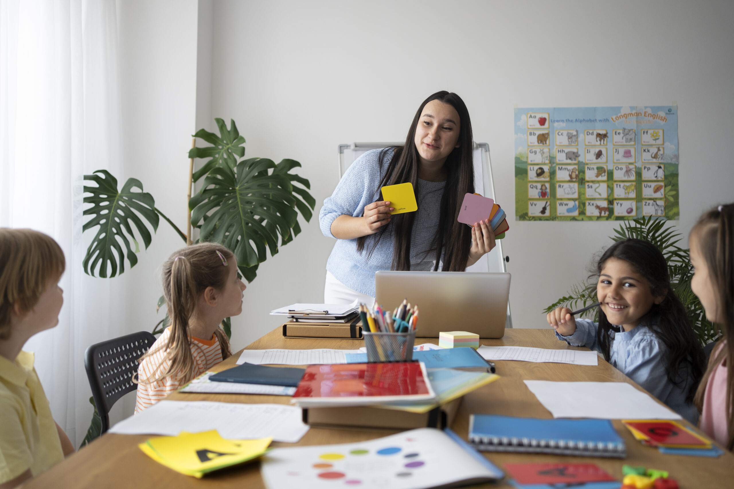 front-view-smiley-teacher-explaining-kids