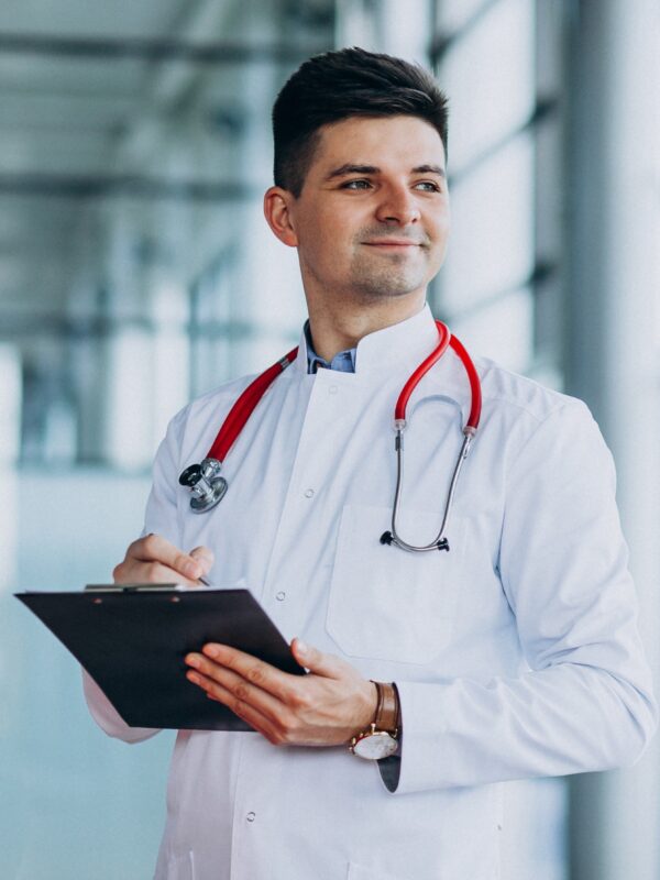 Young handsome physician in a medical robe with stethoscope